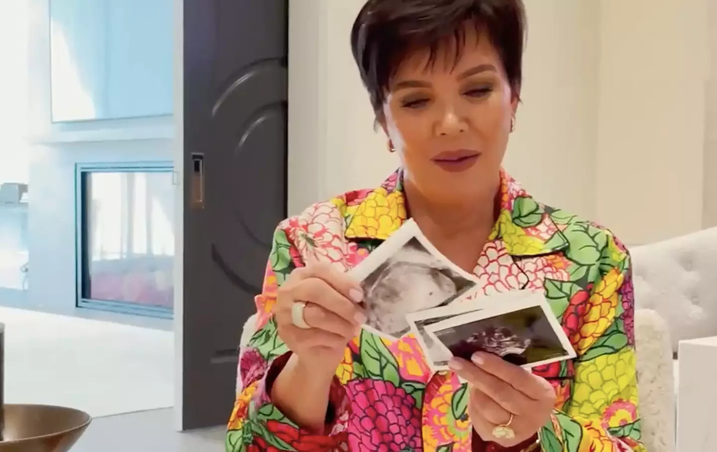 In the 90 second clip, Stormi hands Kris an envelope filled with scan photos (