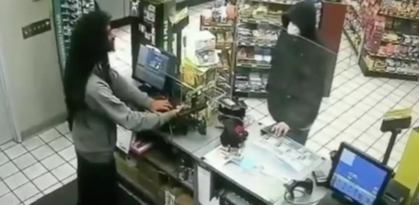 Store clerk readies his gun.