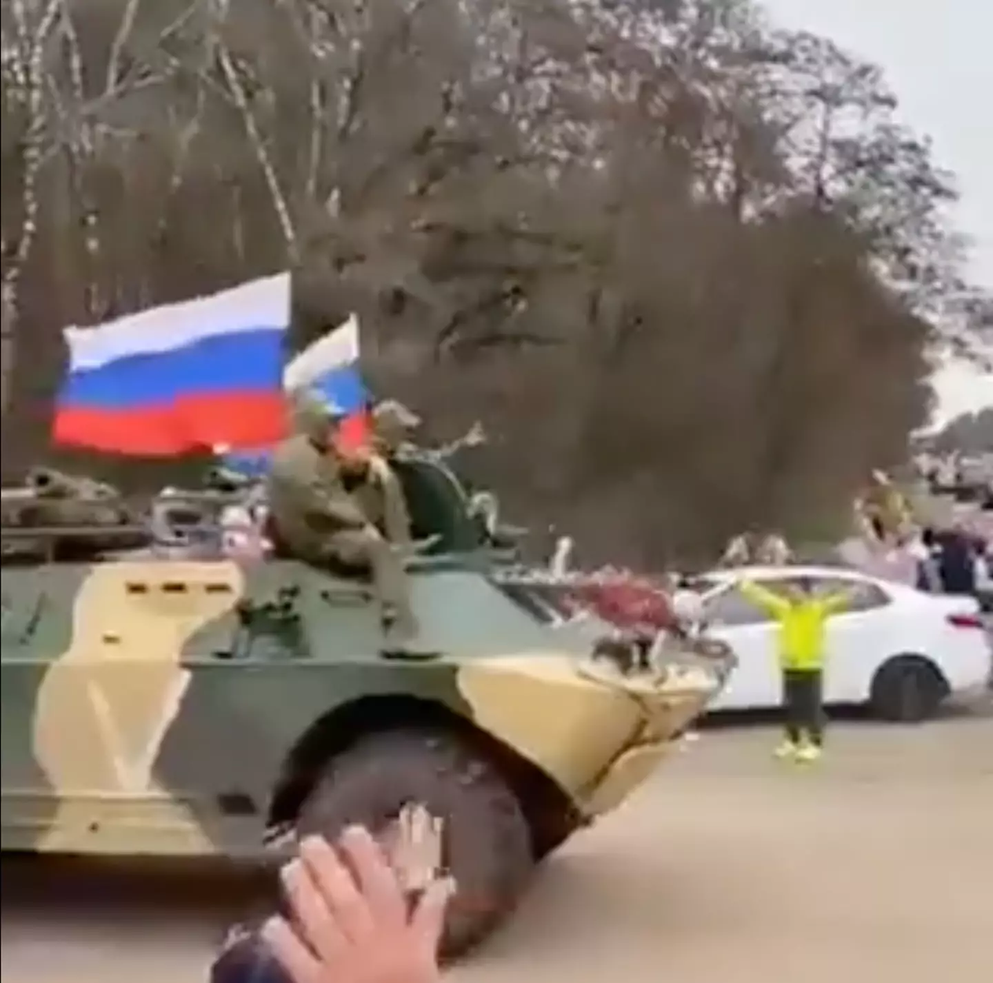 Russian civilians have been recorded cheering troops on as they go to fight in Ukraine.