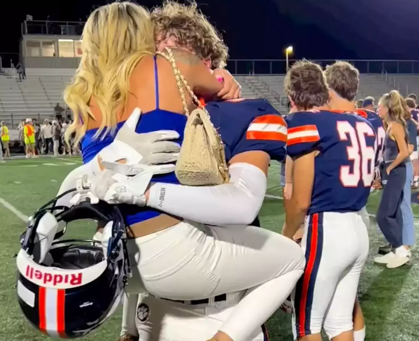 Amber hugged her son after the football game.
