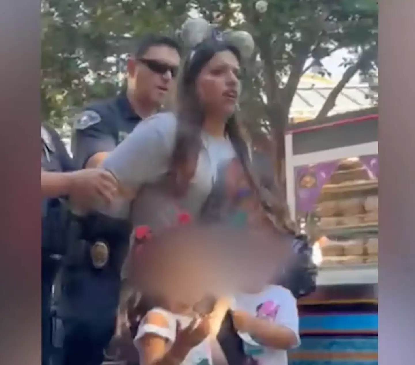 The mom was escorted out of the park with her crying children (KTLA 5)