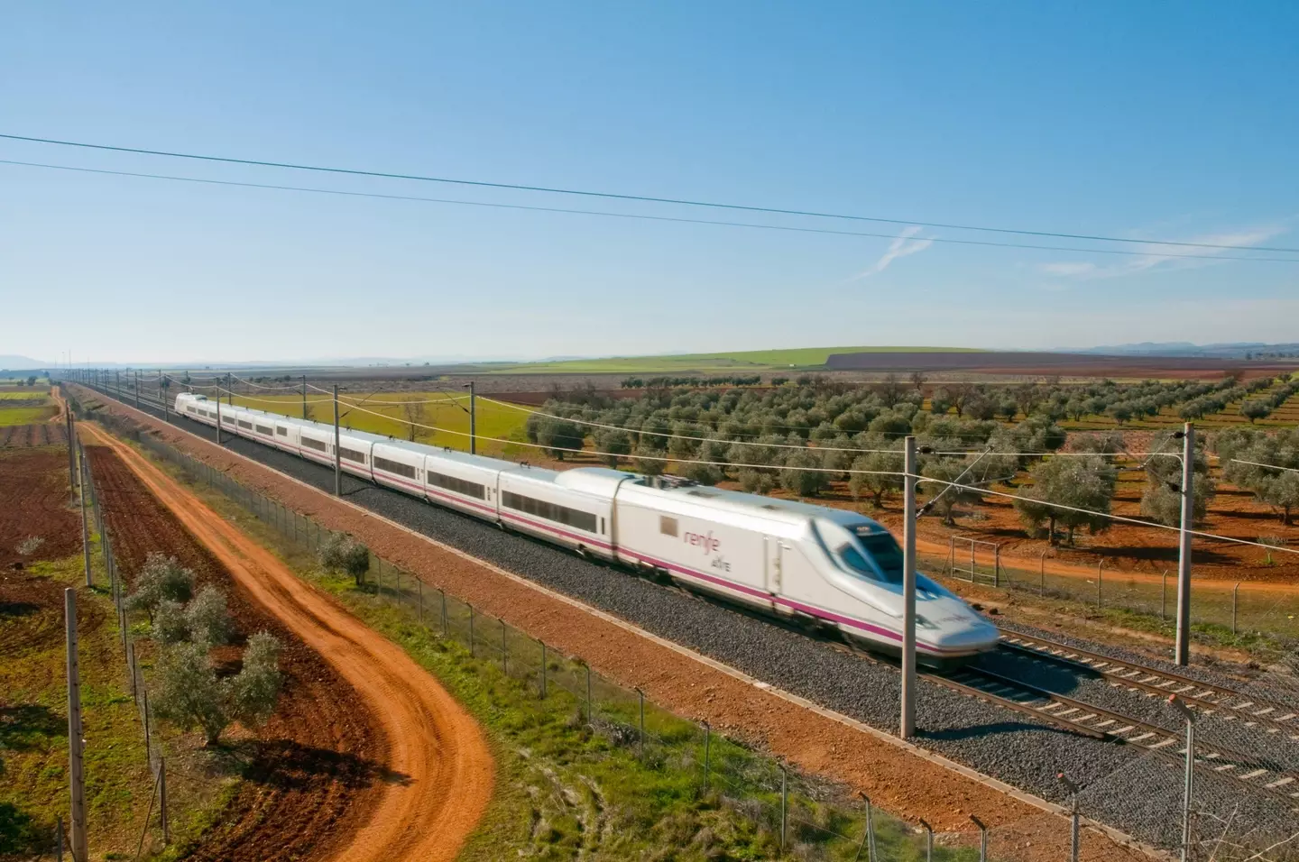 A train in Spain moving freely on the plain.