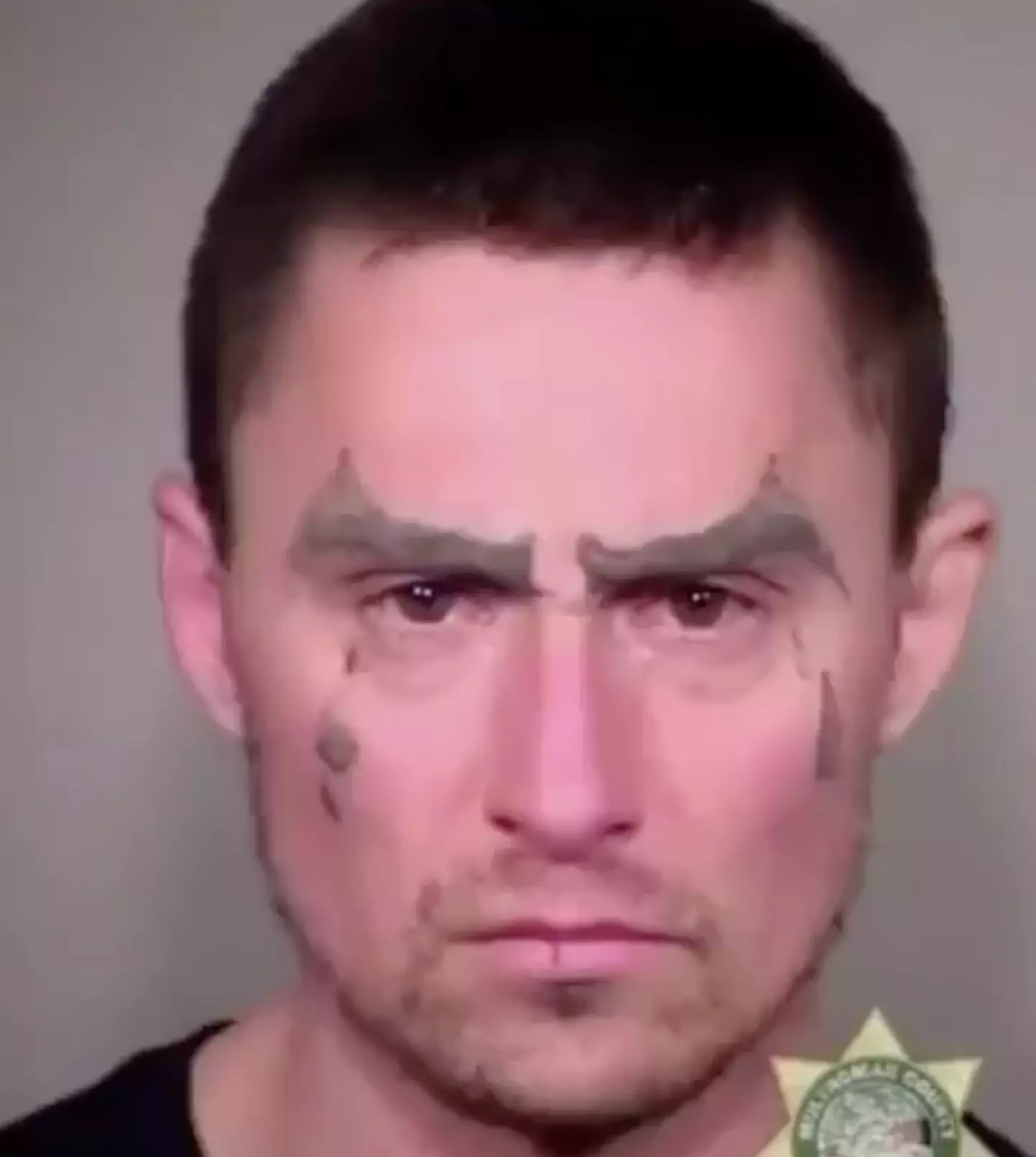 In one, he can be seen with seemingly unfinished eyebrow and tear tattoos.