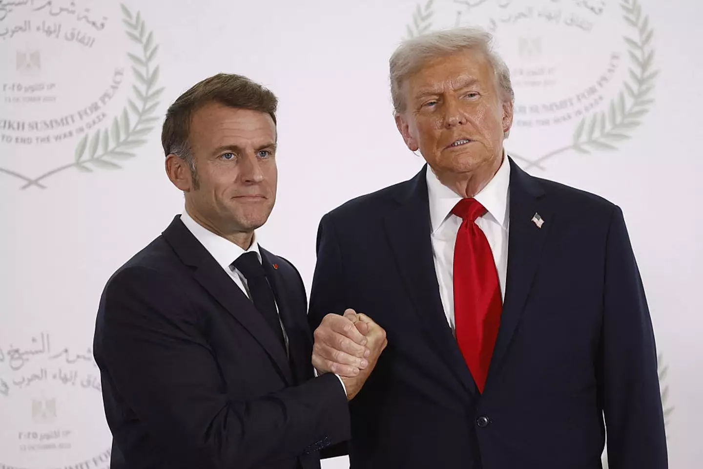 The handshake looked more like a 'death grip' between the presidents (YOAN VALAT/POOL/AFP via Getty Images)