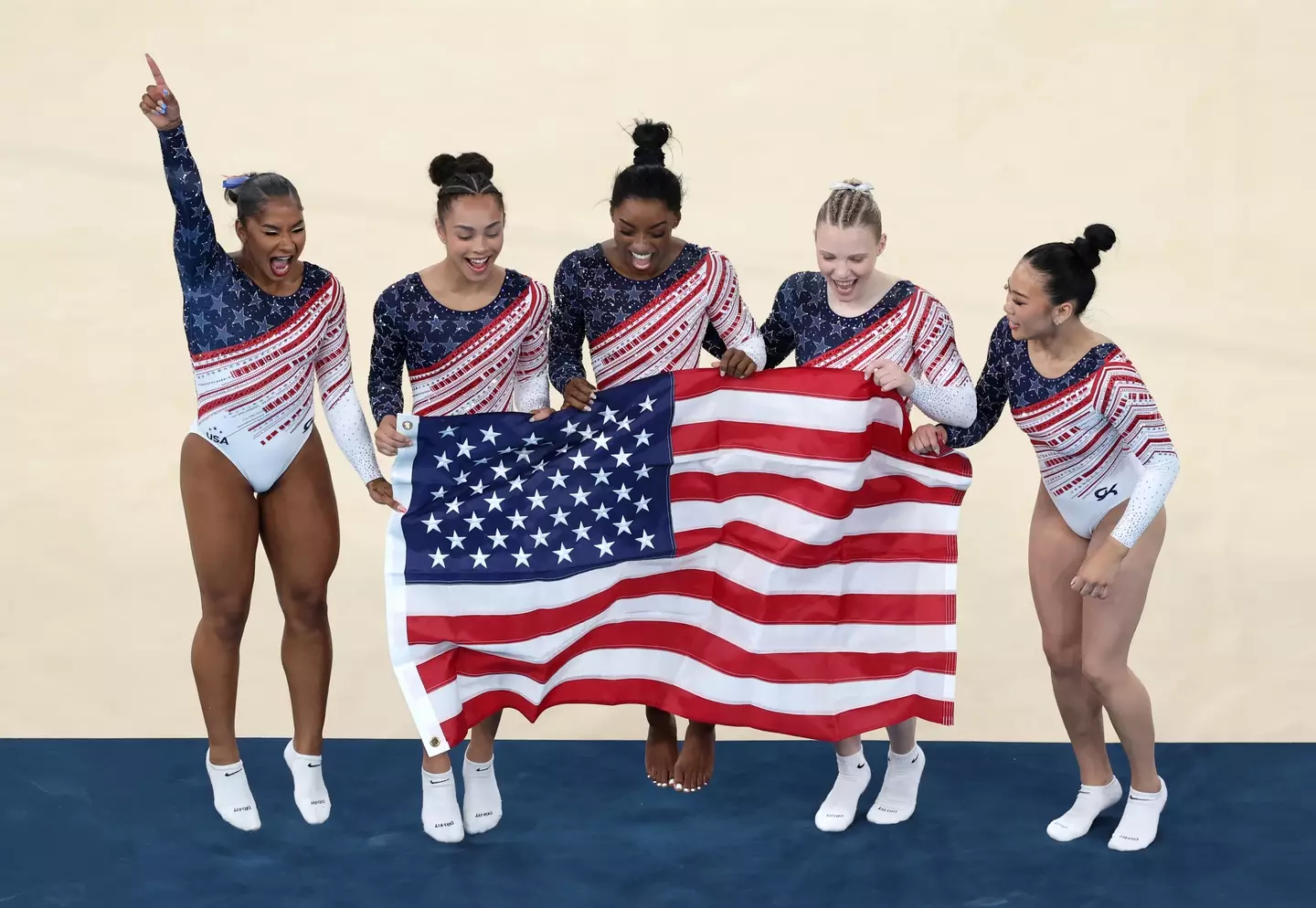 Team USA gymnasts Jordan Chiles, Hezly Rivera, Simone Biles, Jade Carey and Sunisa Le celebrate their victory. (Ezra Shaw/Getty Images)