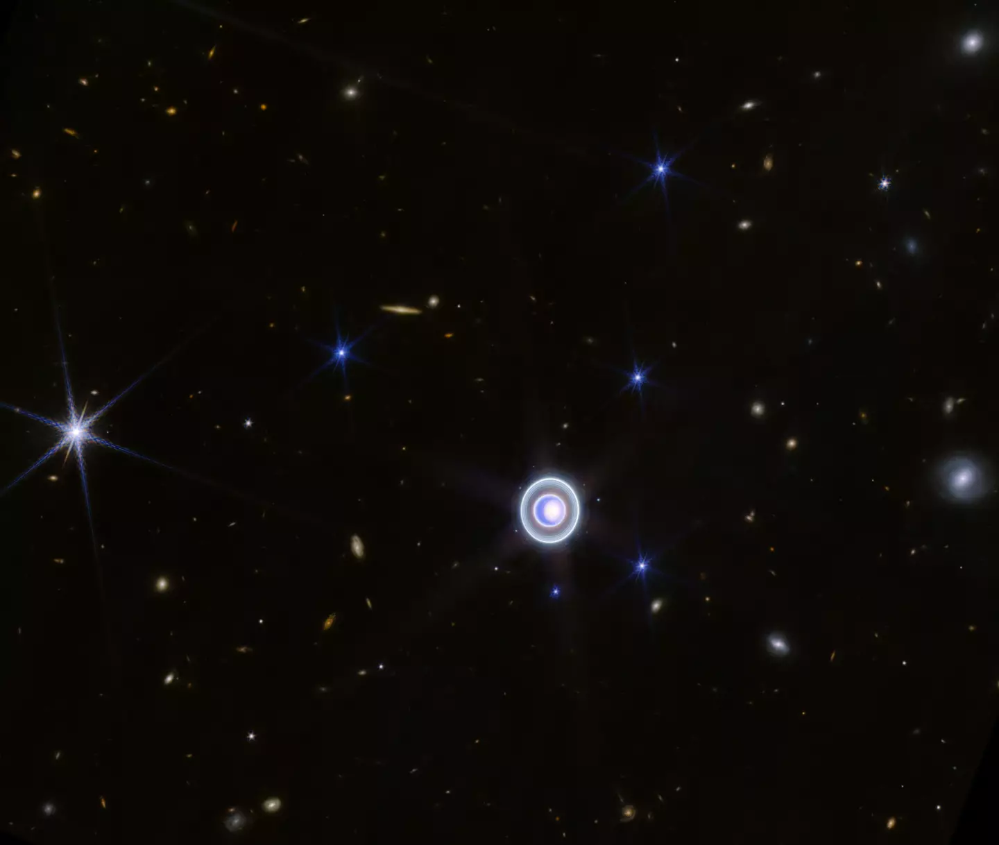 Uranus and some of its 27 moons, as captured by the James Webb Space Telescope in 2023 (NASA)