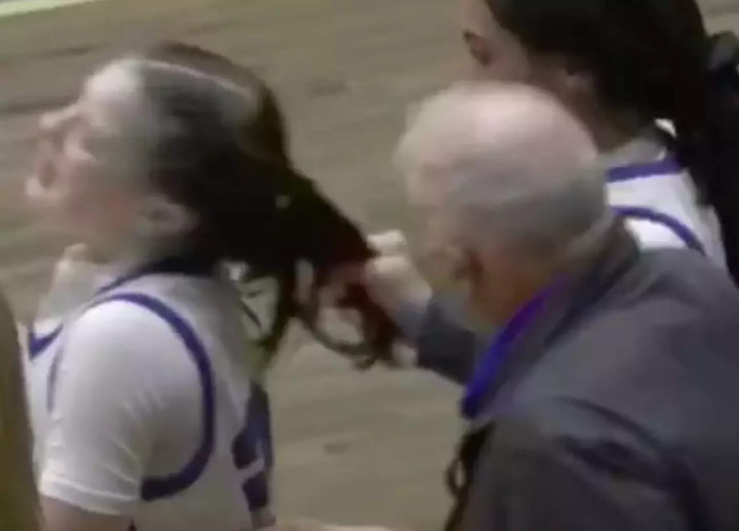 The coach pulled the players hair from behind before appearing to yell at her (YouTube/CBS6Albany)