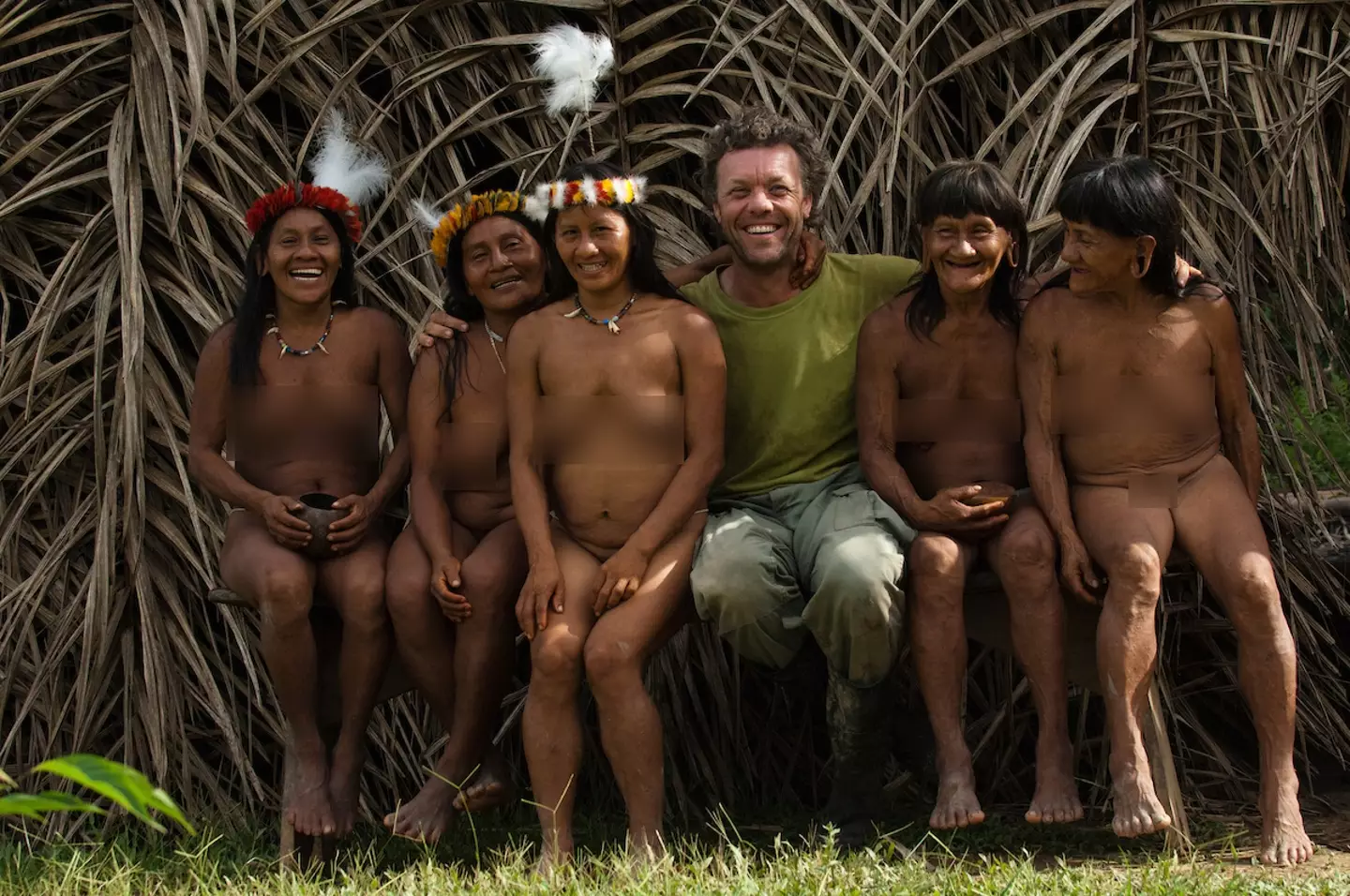 Photographer Pete Oxford seen with some of the tribe's women.
