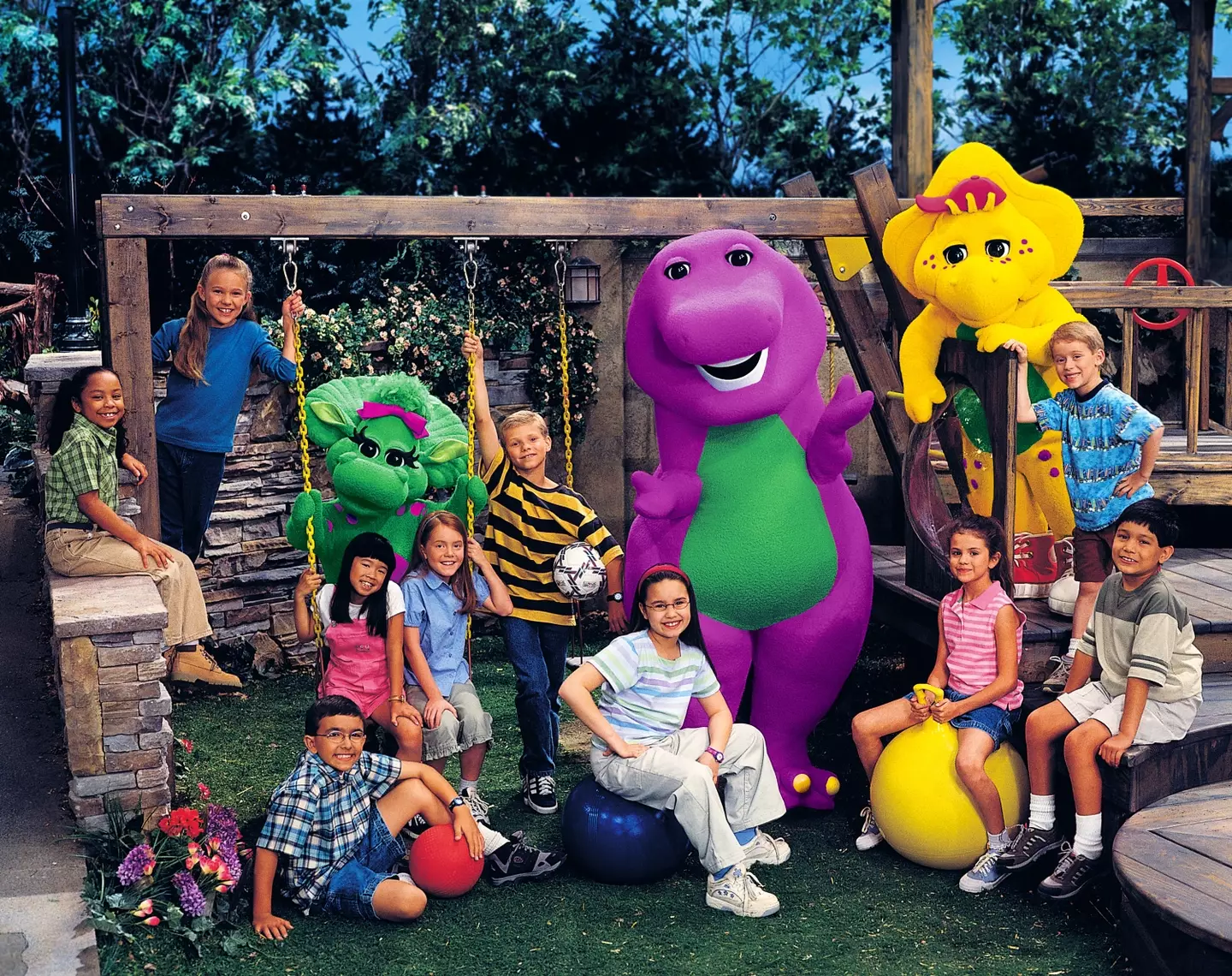BARNEY AND FRIENDS, Barney the dinosaur, Selena Gomez (on yellow ball), Demi Lovato (wearing glasses and red headband) (1992).