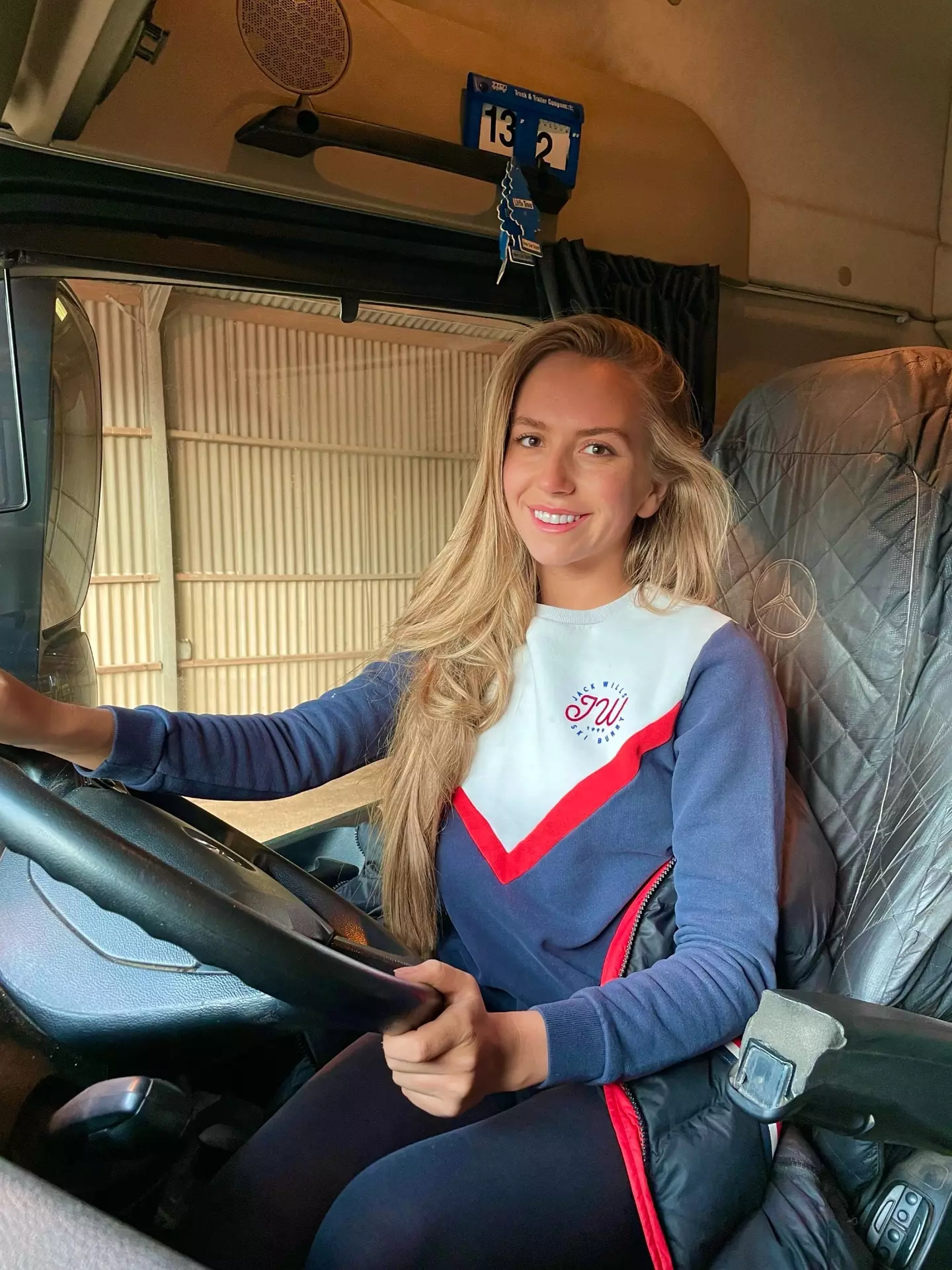 Milly Everatt in her lorry (SWNS)