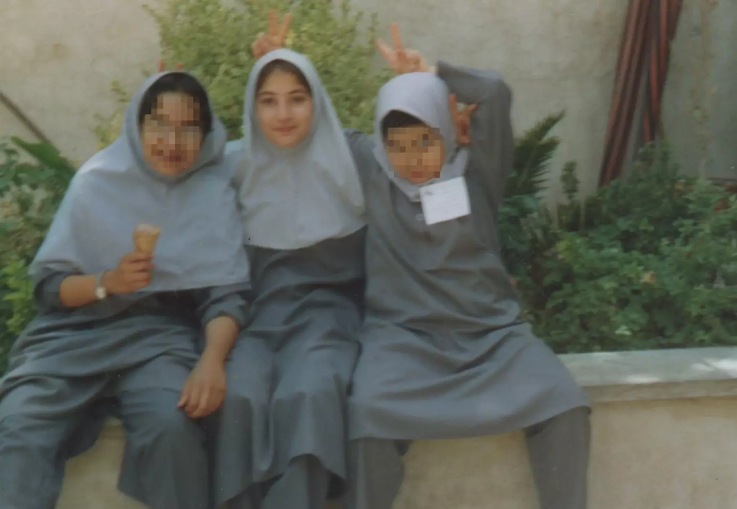 Sahar in a hijab aged 12, with classmates in Iran.