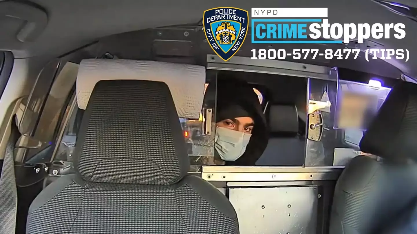 The suspect looks directly at a camera while speaking to a cab driver following the murder of Brian Thompson (DCPI)