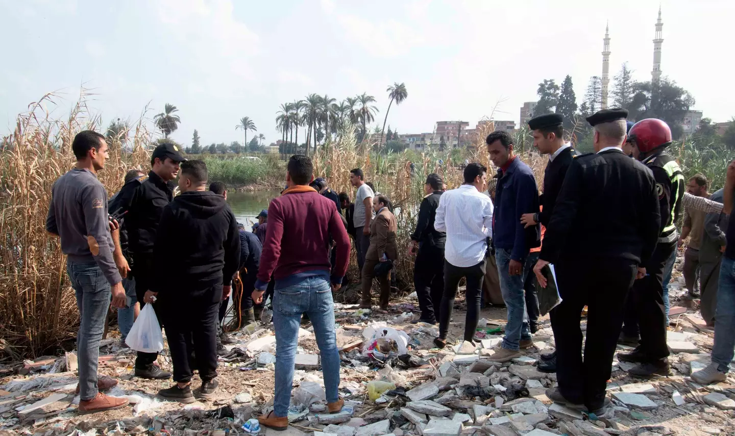People gather at the site after a minibus fell into a canal in Dakahlia province.