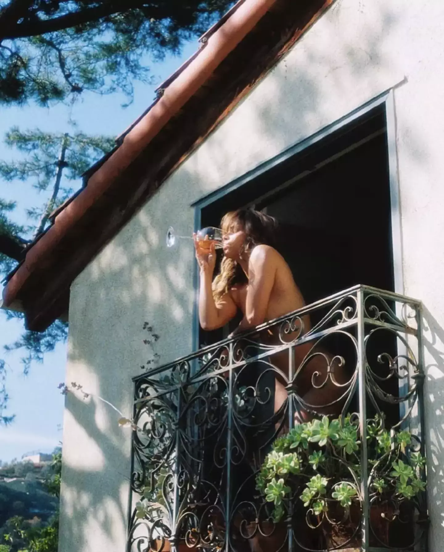 Halle Berry posted a naked photograph of herself drinking wine on a balcony on Instagram.