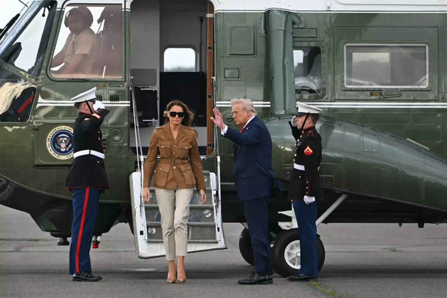 Melania Trump and her husband outside of their Marine One helicopter (ANDREW CABALLERO-REYNOLDS/AFP via Getty Images)