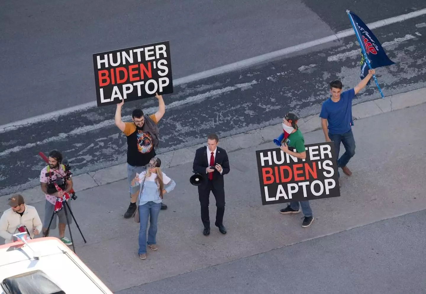 Donald Trump supporters with 'Hunter Biden laptop' signs.