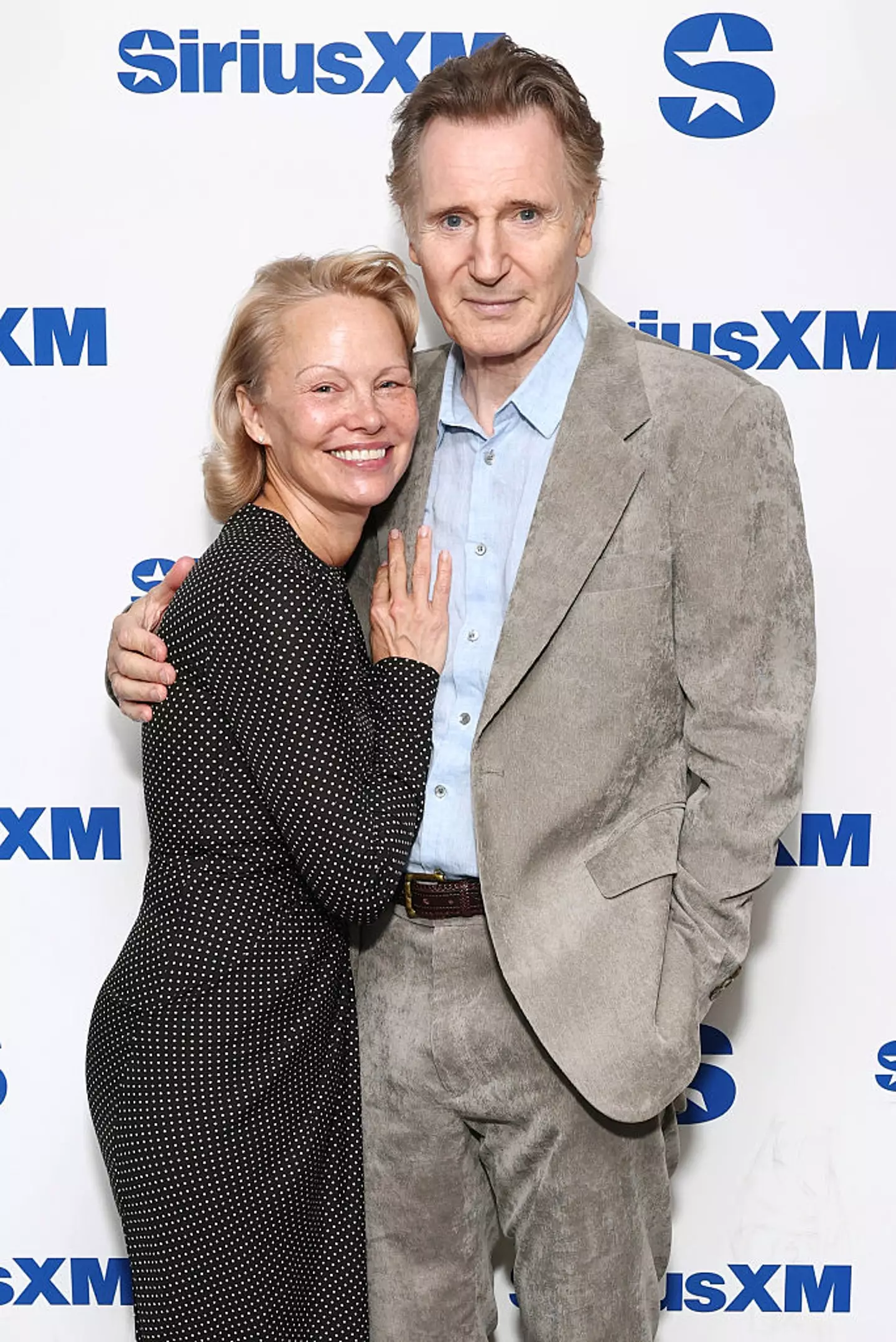 It's been suggested that Pamela Anderson and Liam Neeson faked their rumored romance (Cindy Ord/Getty Images for SiriusXM)