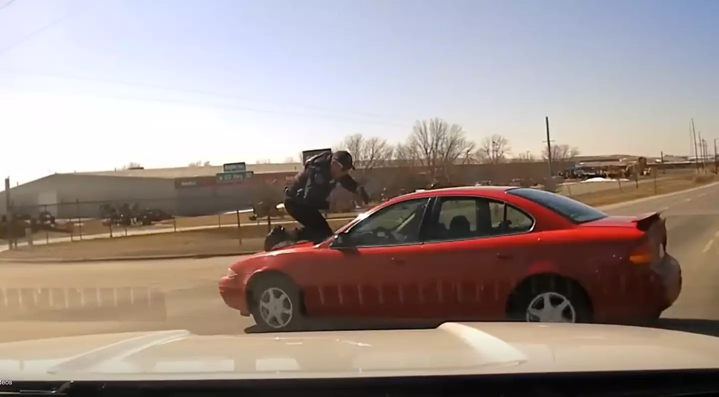 Police officer Patrick McCarty clung onto the speeding car of a suspect.