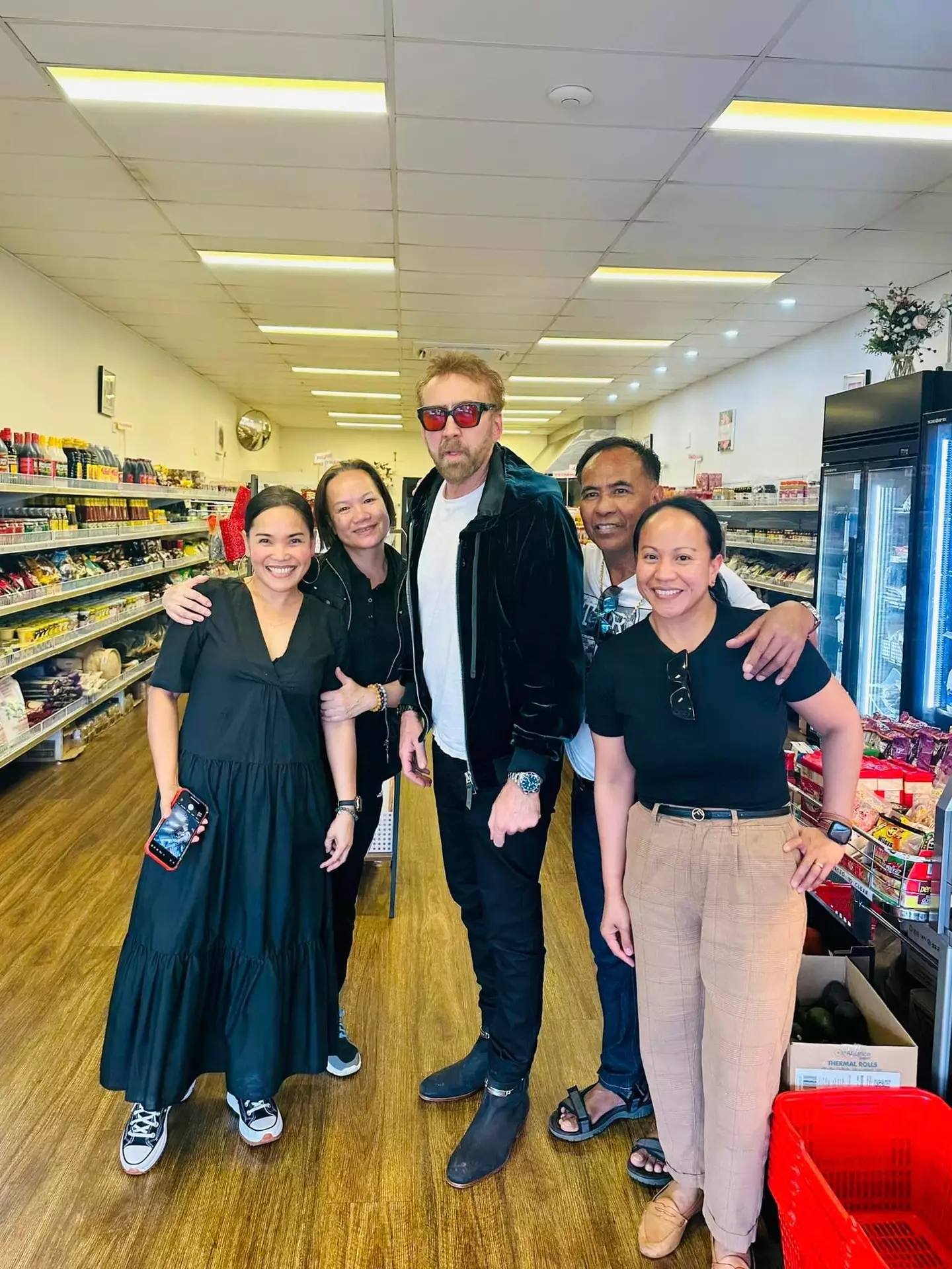 Nicolas Cage posed for a picture with the staff at the shop.