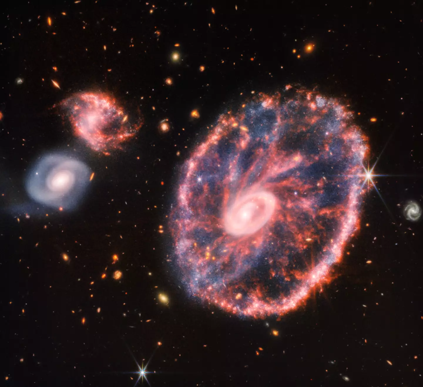 The cartwheel galaxy is prettier than we could've imagined.