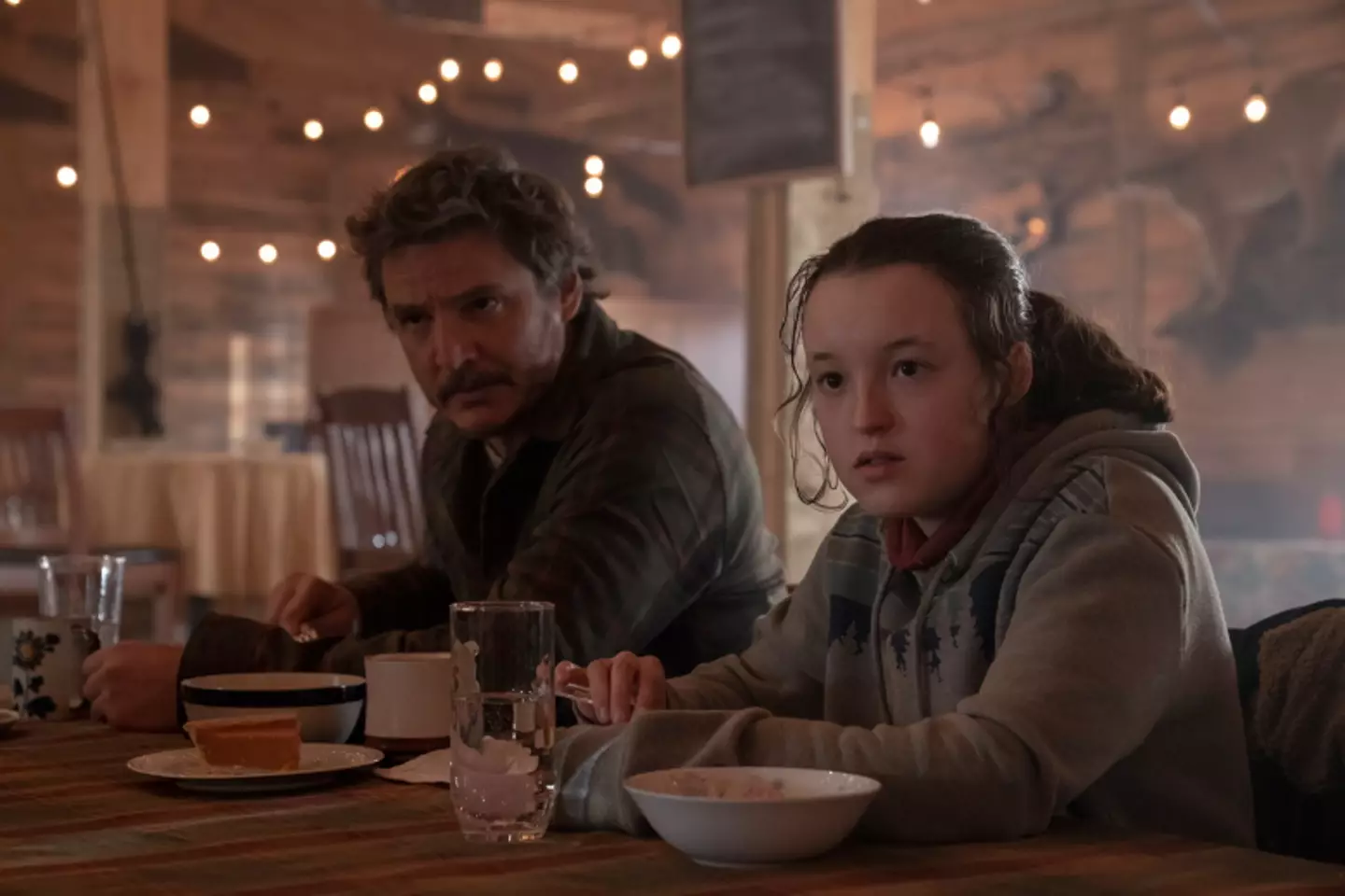 Pedro Pascal as Joel and Bella Ramsey as Ellie in a scene of episode six of The Last of Us.