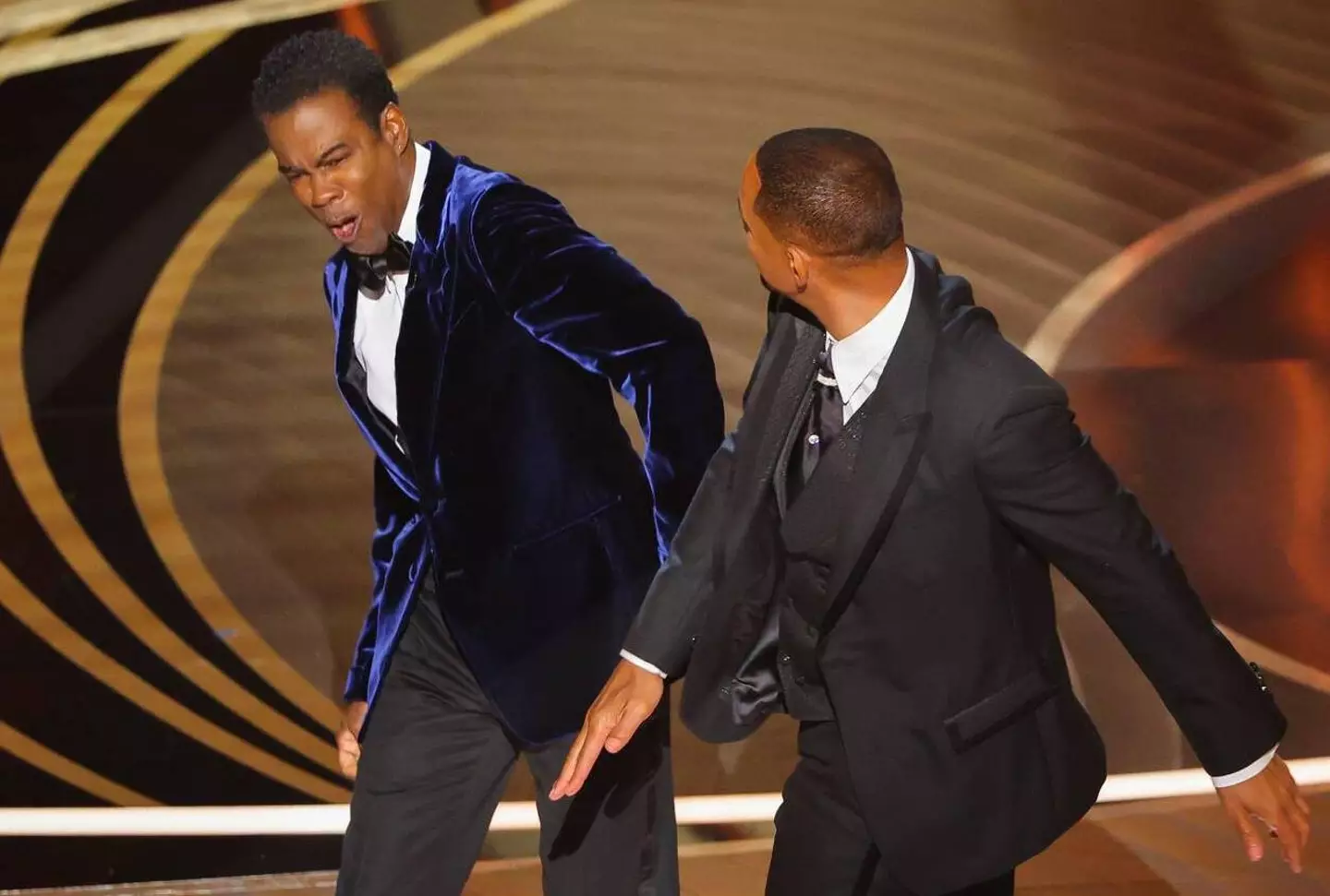 Will Smith slaps Chris Rock.