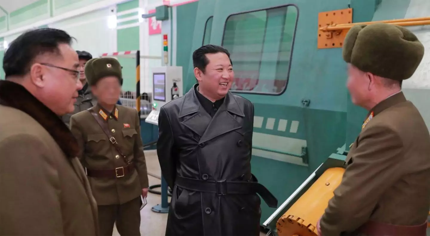 Kim Jong-un in a leather trench coat.