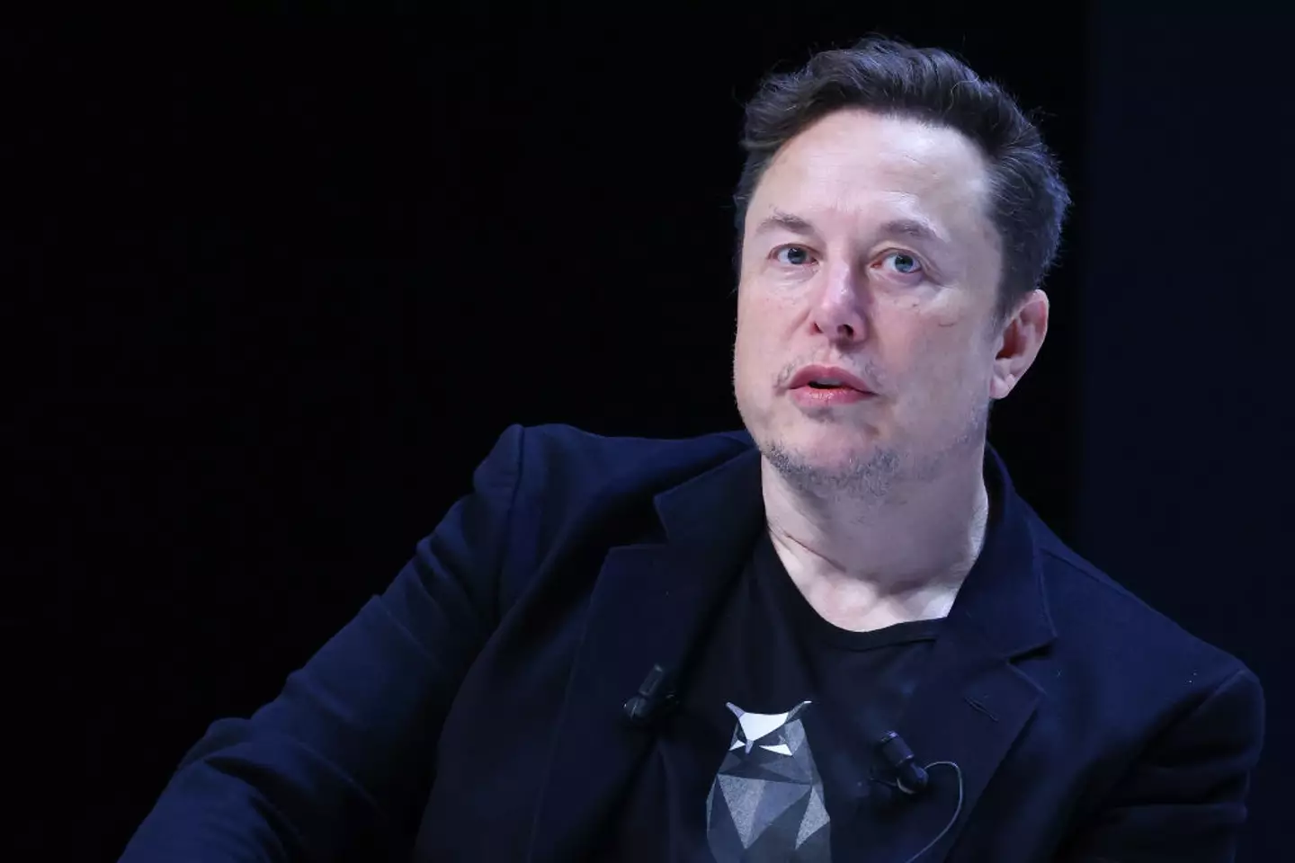 Elon Musk favors the two-hands approach. (Marc Piasecki/Getty Images)