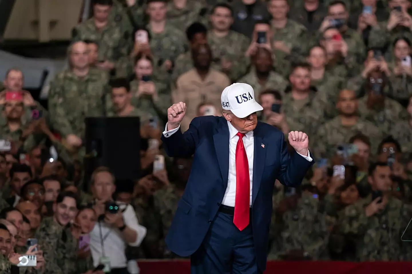 President Donald Trump dances as he speaks to troops aboard USS George Washington, on Tuesday, in Yokosuka, Japan (Tomohiro Ohsumi/Getty Images)