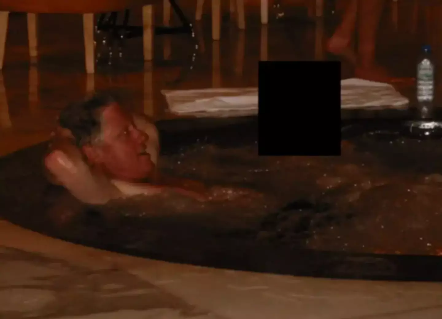 Another photo sees Clinton in what appears to be a hot tub (Department of Justice)