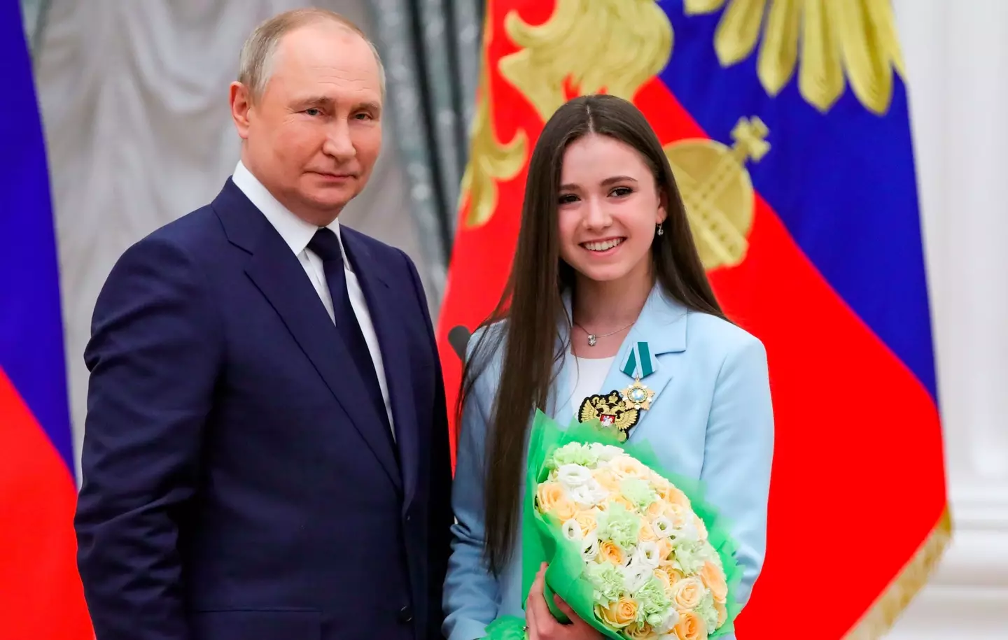 Vladimir Putin poses for a photo with Kamila Valieva.