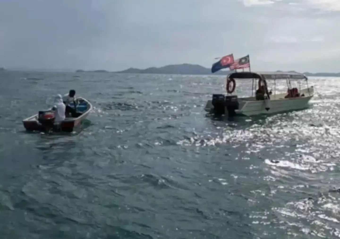 Four divers have been reported missing near a Malaysian island.