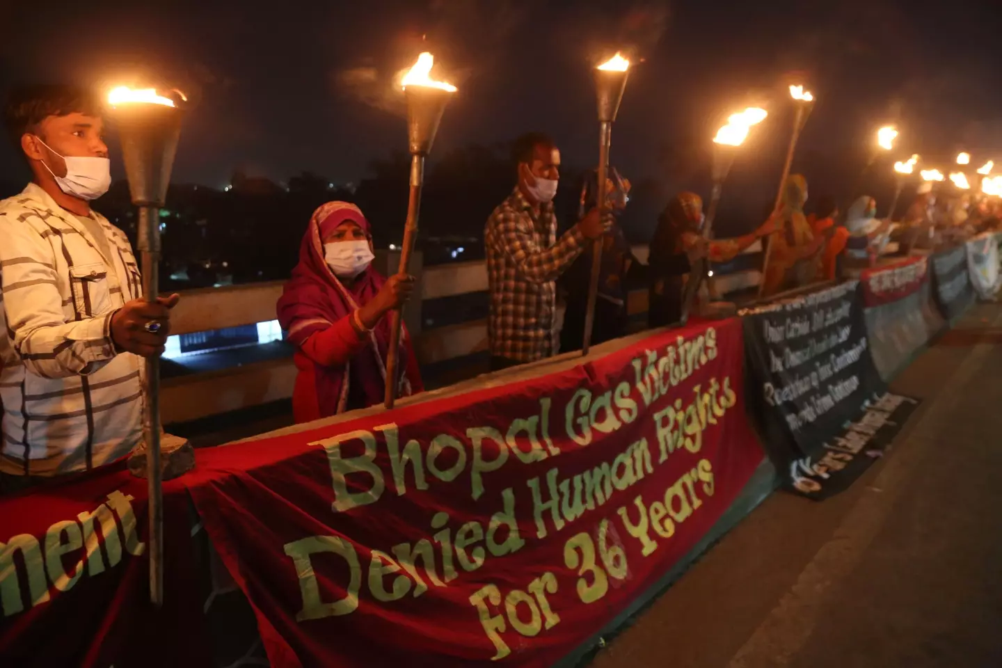 Survivors and activists gather outside the defunct factory in 2020. GAGAN NAYAR/AFP via Getty Images