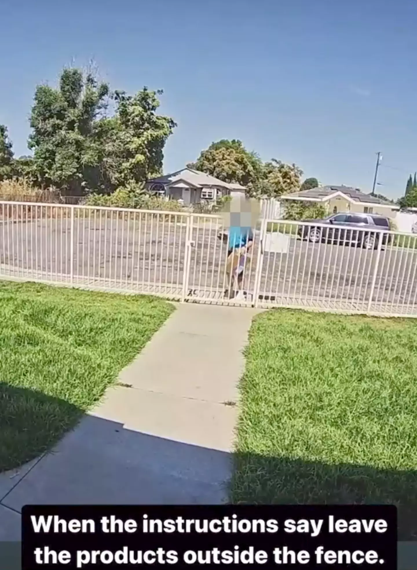 The delivery driver tries to carefully place the package on the ground.