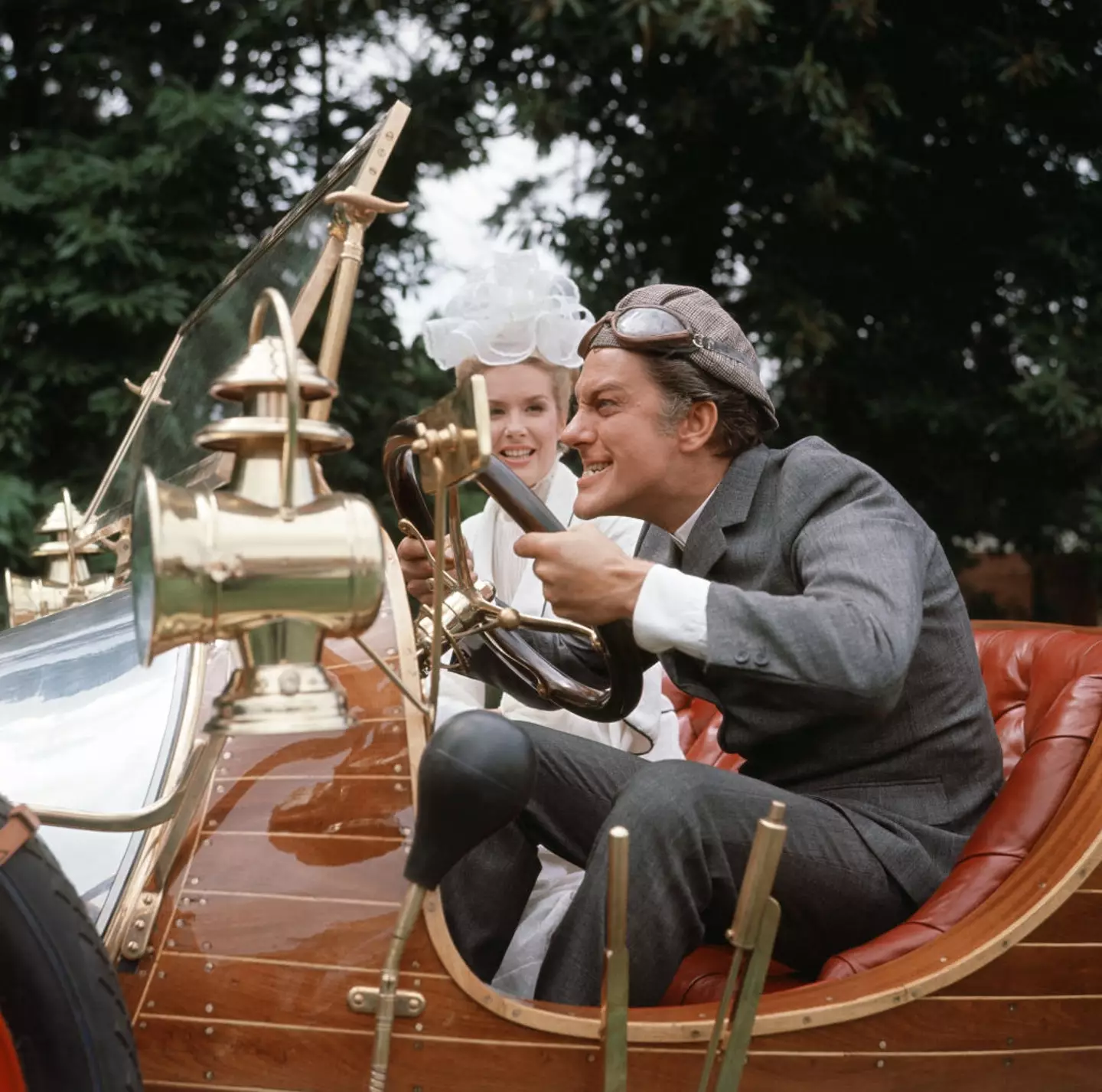 American actor Dick van Dyke and actress Sally Ann Howes with the car which co-stars in their film 'Chitty Chitty Bang Bang' during production at Pinewood Studios. Dick Van Dyke plays Caractacus Potts with Sally Ann Howes as Truly Scrumptious in 1967 (Crawshaw /Mirrorpix/Getty Images)