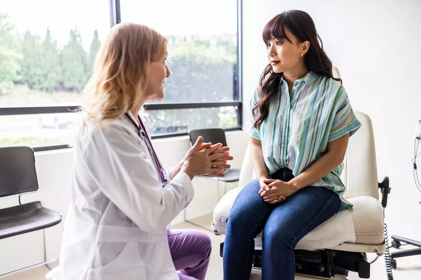 Female doctor talking with young woman in exam room (MoMo Productions/Getty Images)
