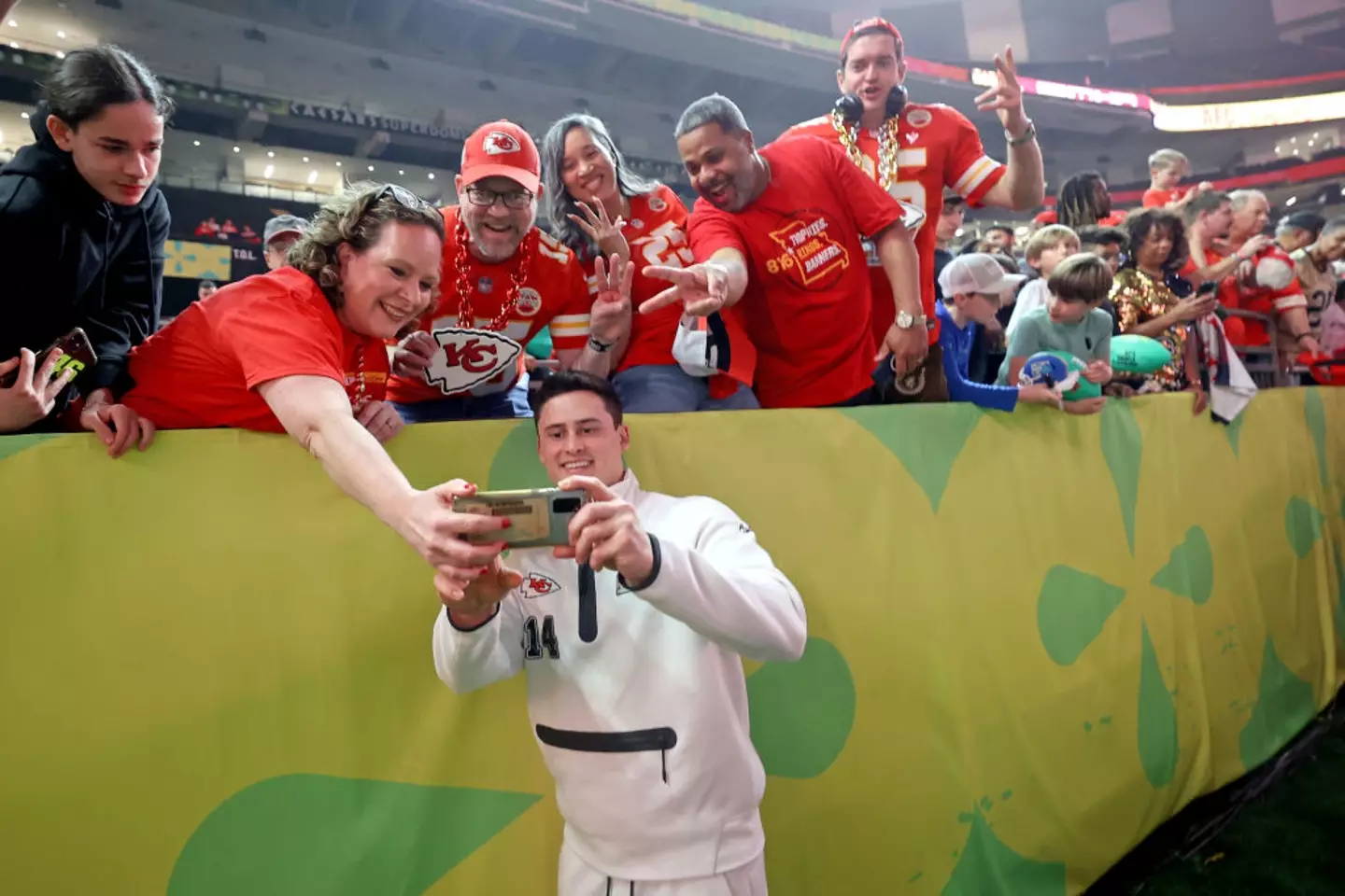 Kansas City Chiefs punter Matt Araiza takes a selfie with Chiefs fans inside the Caesars Superdome during the Super Bowl Opening Night in New Orleans, Louisiana (Michael DeMocker/Getty Images)
