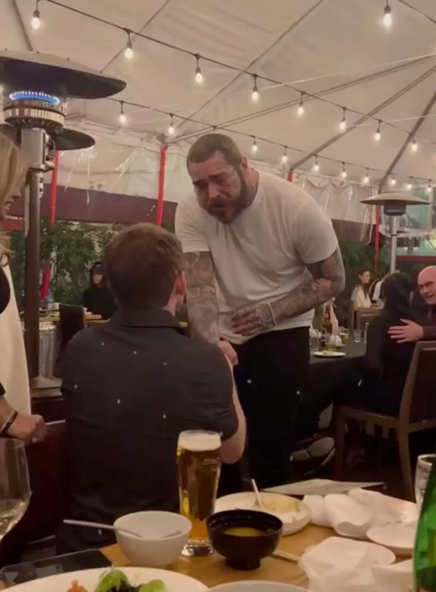Post Malone met a fan at a restaurant.