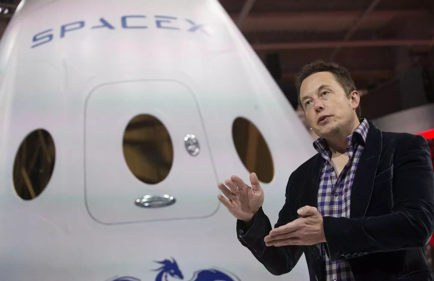 Elon Musk in front of a SpaceX shuttle.