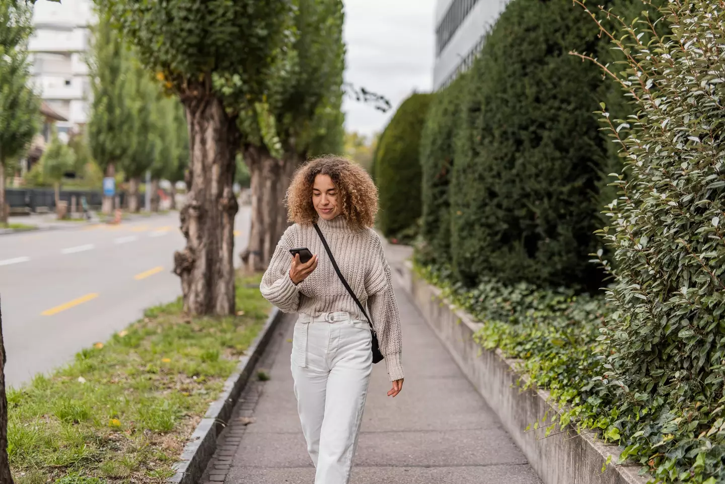 Many of us are guilty of walking while looking down at our phones (Getty Stock Image)