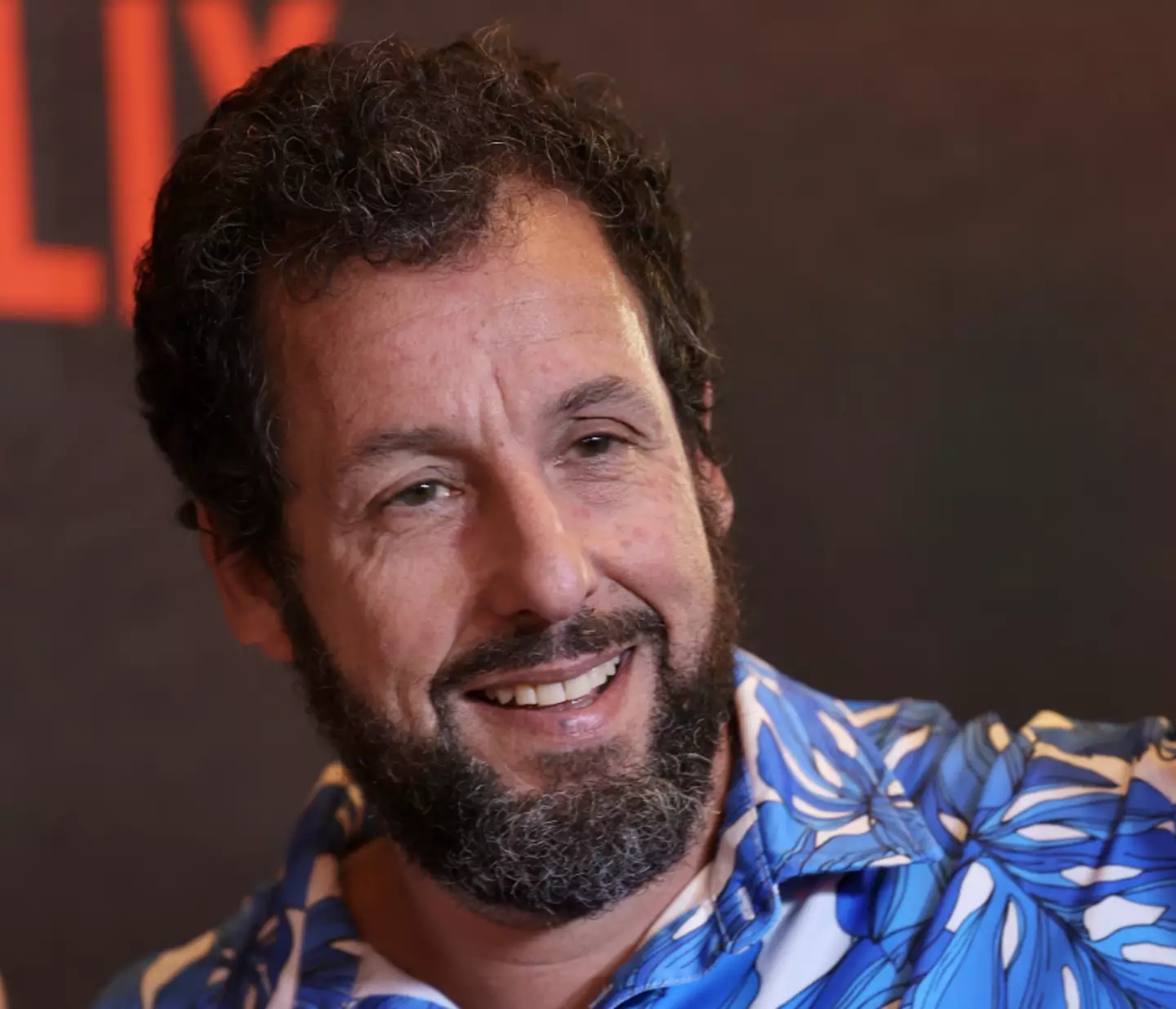 Sandler encouraged the audience to cheer for the fan as they left.