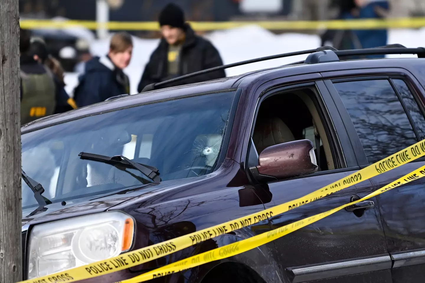 Police tape surrounds a vehicle suspected to be involved in a shooting by an ICE agent during federal law enforcement operations (Stephen Maturen/Getty Images)