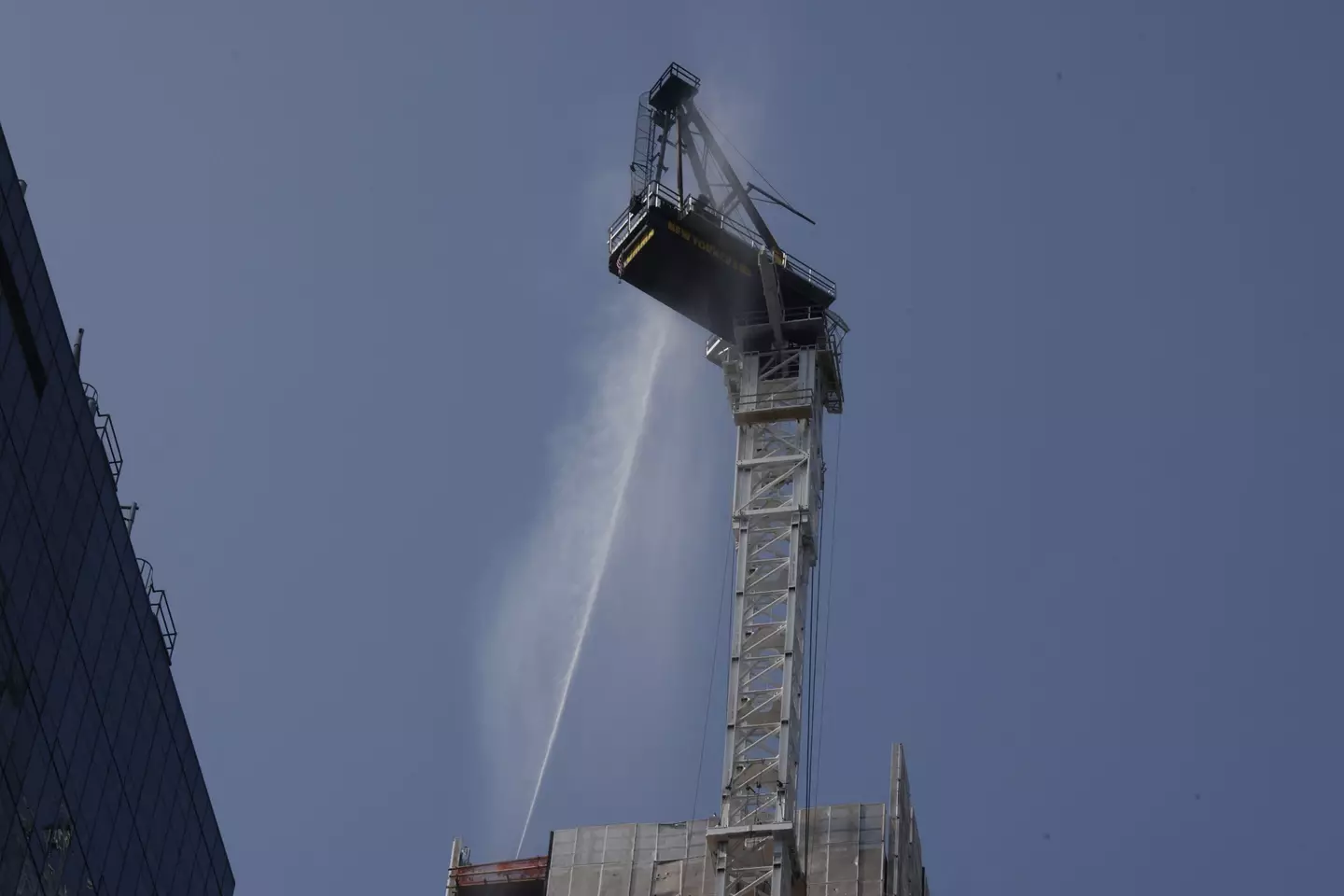 Firefighters worked to put out the broken and burning crane.