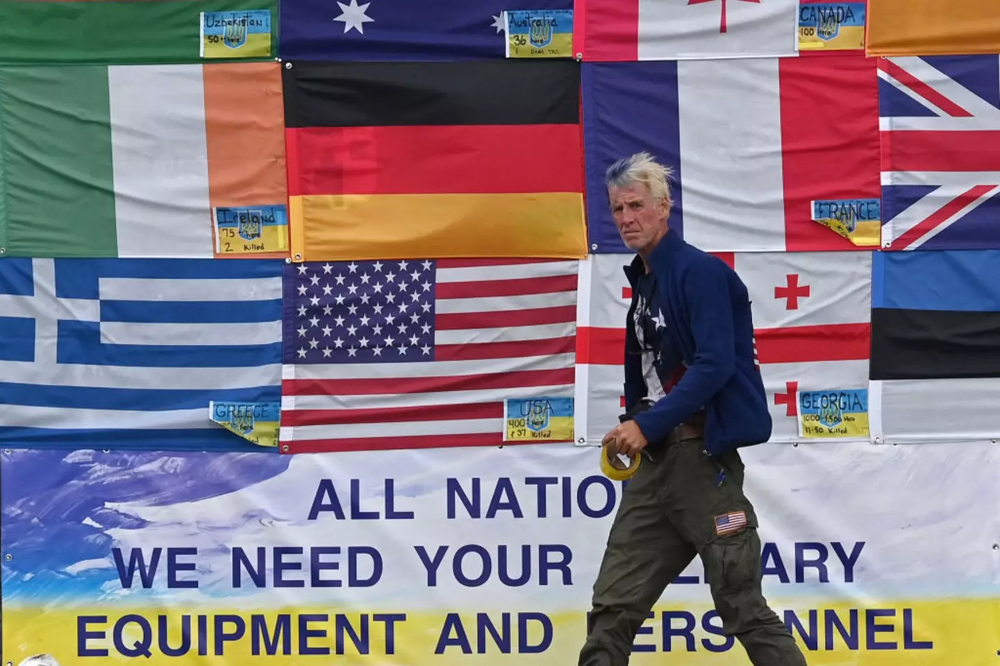 This photograph taken on Independence Square in Kyiv on June 23, 2022 shows US citizen Ryan Wesley Routh sticking up national flags of the countries helping Ukraine (SERGEI SUPINSKY/AFP via Getty Images)