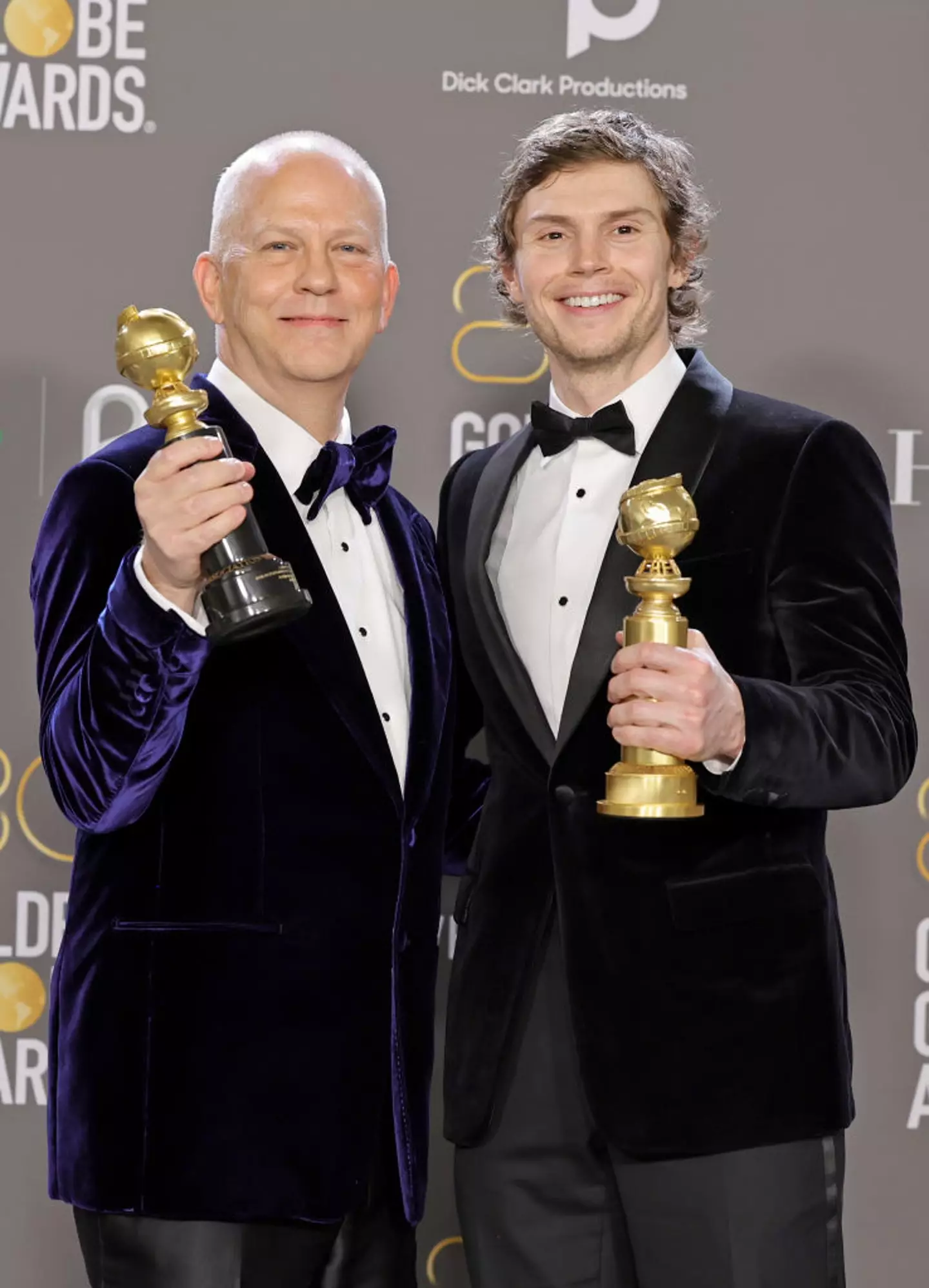 Ryan Murphy grips a Golden Globe for the Carol Burnett Award, and Evan Peters, holds his for the Best Actor in a Limited or Anthology Series or Television Film award, which they both received Monster: The Jeffrey Dahmer Story. Will Murphy win one again? (Amy Sussman/Getty Images)