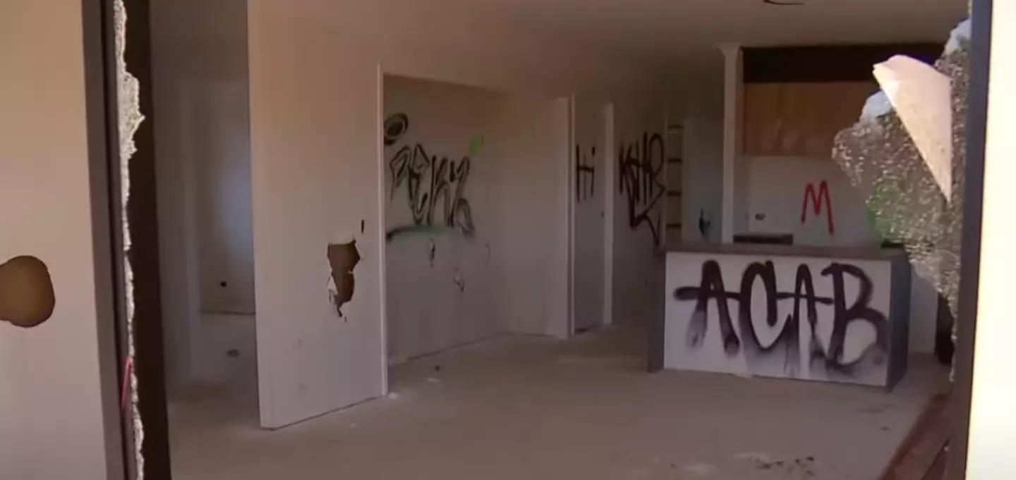 Images show smashed windows and graffiti in the home.
