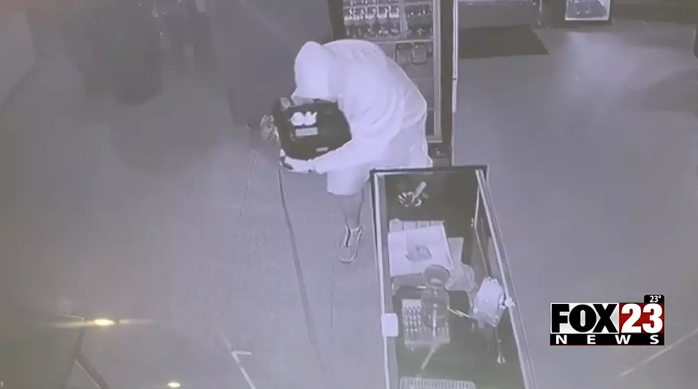 The thief struggled to flee with the cash register. (Fox 23)