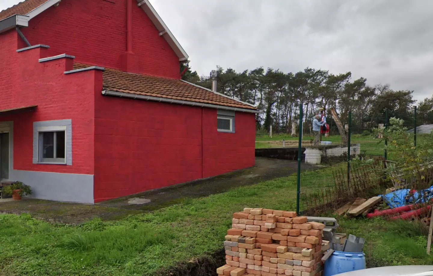 Landrieux's husband was hanging up washing in their back garden at the very moment she crossed the road - captured in the same shot (Google Maps)