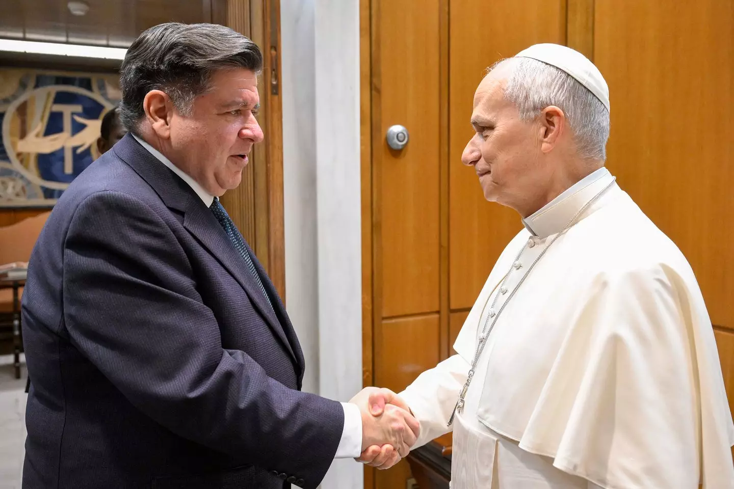 Governor Pritzker (left) signed the bill into law (Vatican Pool/Getty Images)