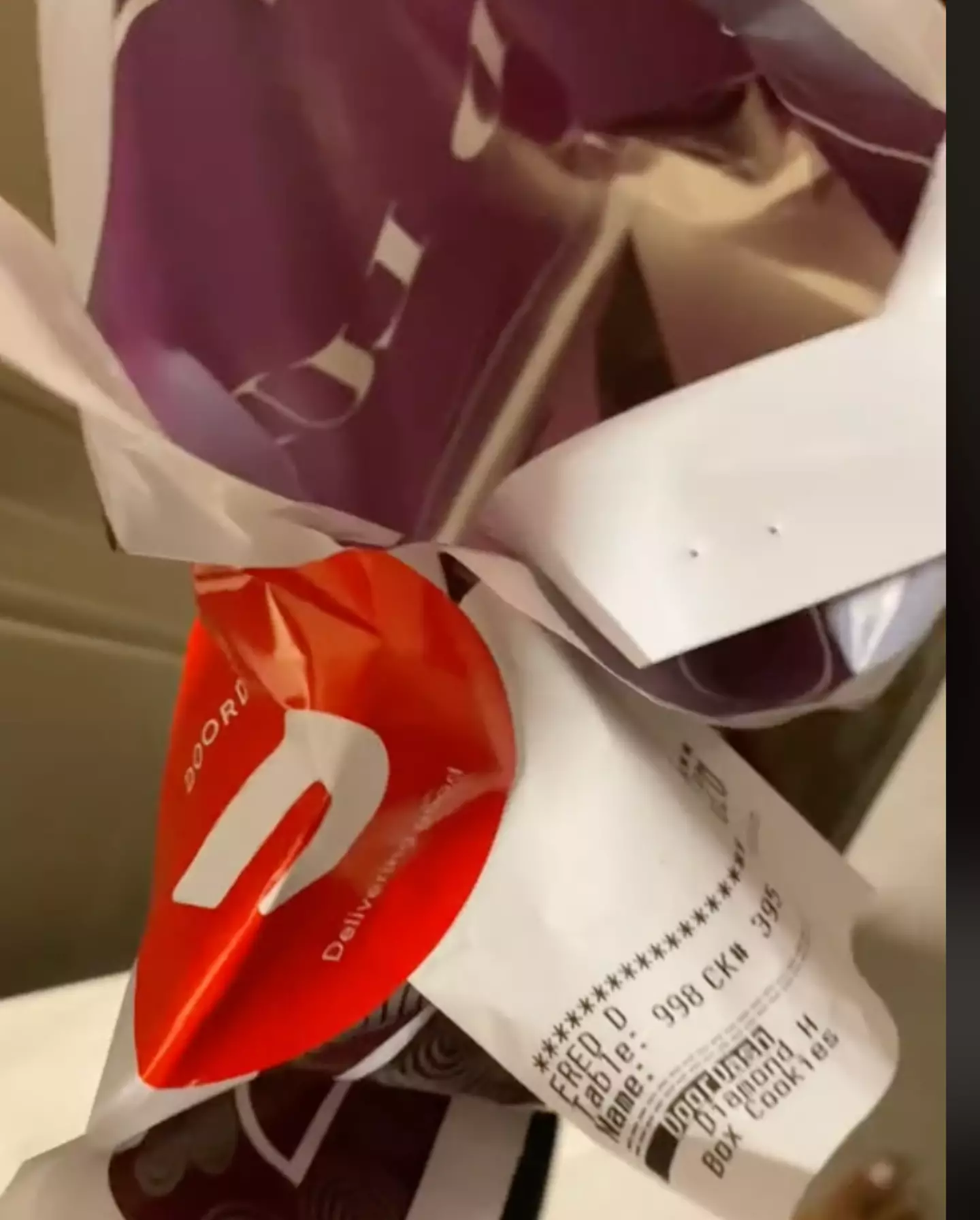 The driver bafflingly checked the bag he had handed the customer as she questioned him on why it was open.